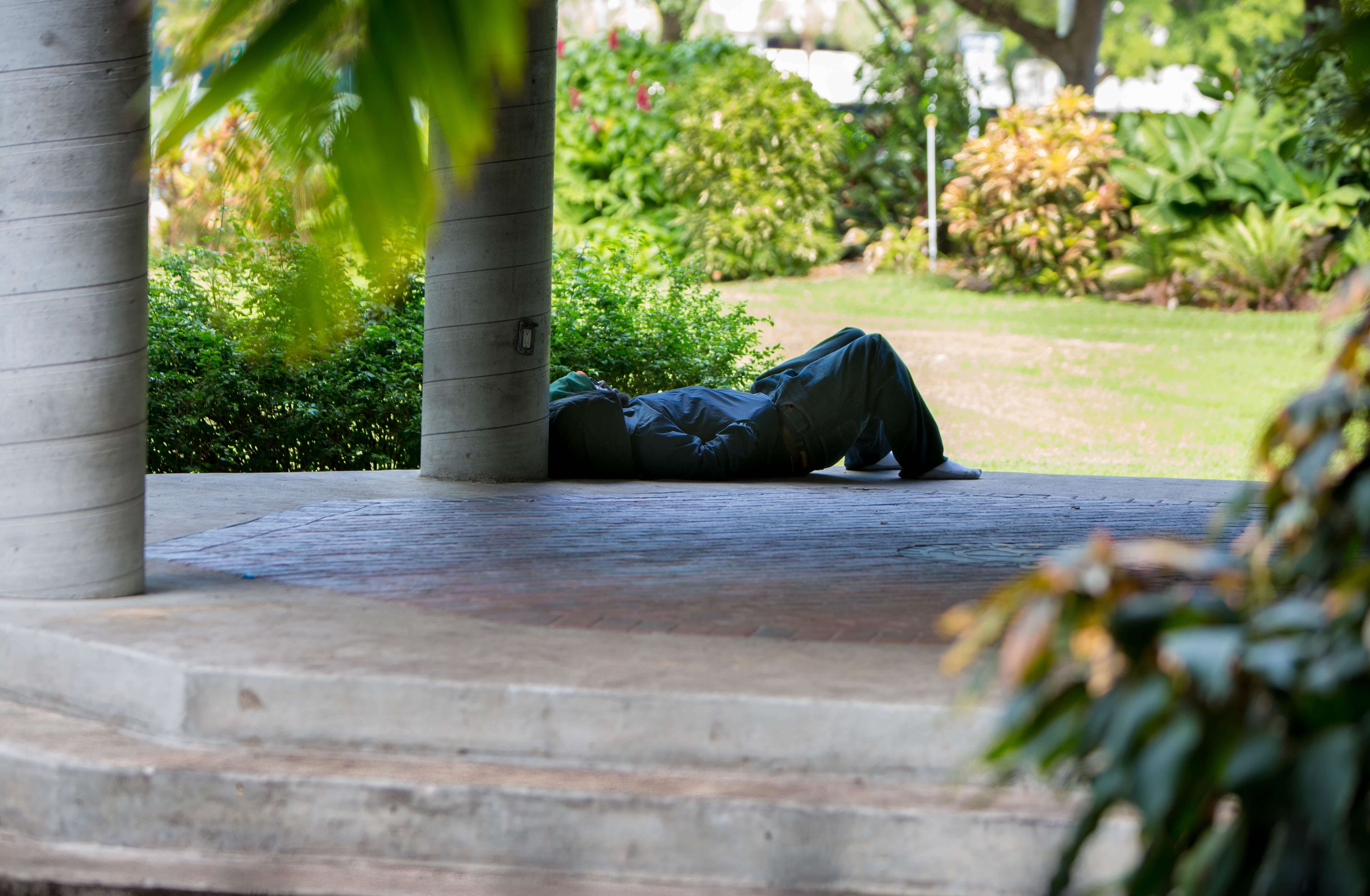 A homeless person relaxes near the encampment in downtown Fort Lauderdale