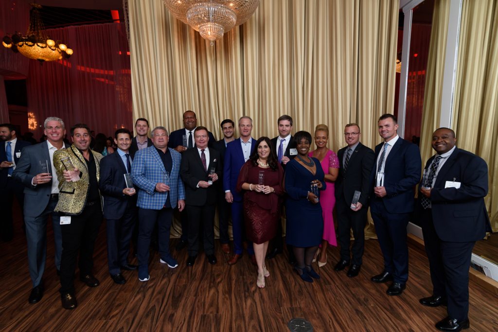 Apogee Awards honorees and guests gather for a photo at the end of the celebration