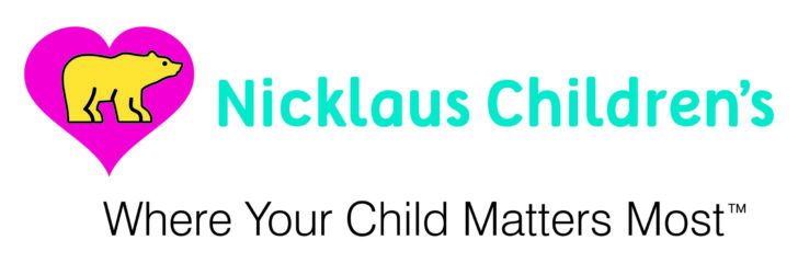 Logo for Nicklaus Children&acirc;s, featuring a yellow bear inside a pink heart, with the text "Nicklaus Children&acirc;s" in teal and "Where Your Child Matters Most&acirc;&cent;" in black below. South Florida Business & Wealth