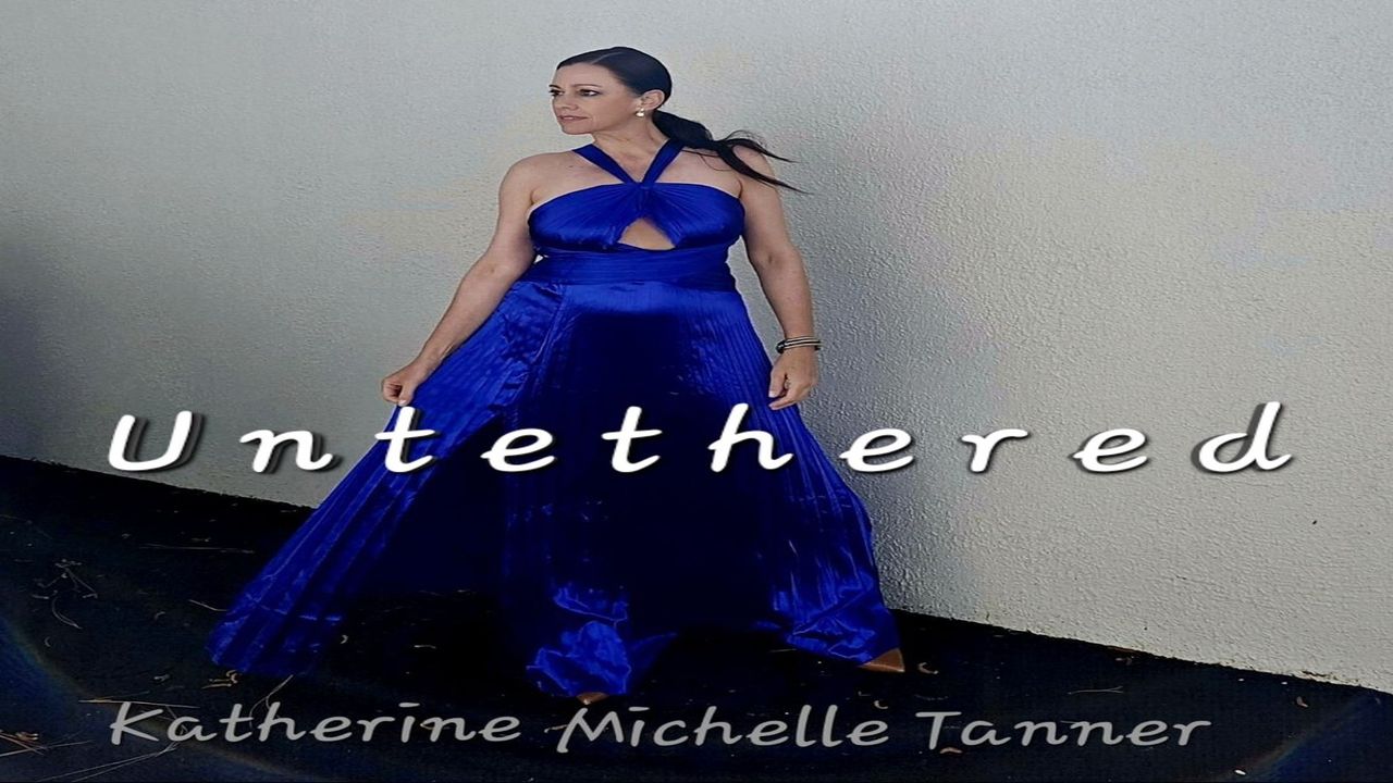 A woman in a bright blue, flowing gown stands against a pale wall. The text "Untethered" is centered across the image, with "Katherine Michelle Tanner" at the bottom. South Florida Business & Wealth