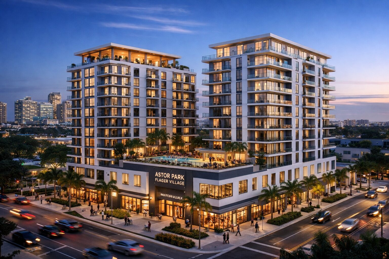 A modern apartment complex with two tall buildings, large balconies, and a rooftop pool, located at a busy intersection at dusk. The sign reads "Astor Park Flagler Village." Palm trees and city lights are visible. South Florida Business & Wealth