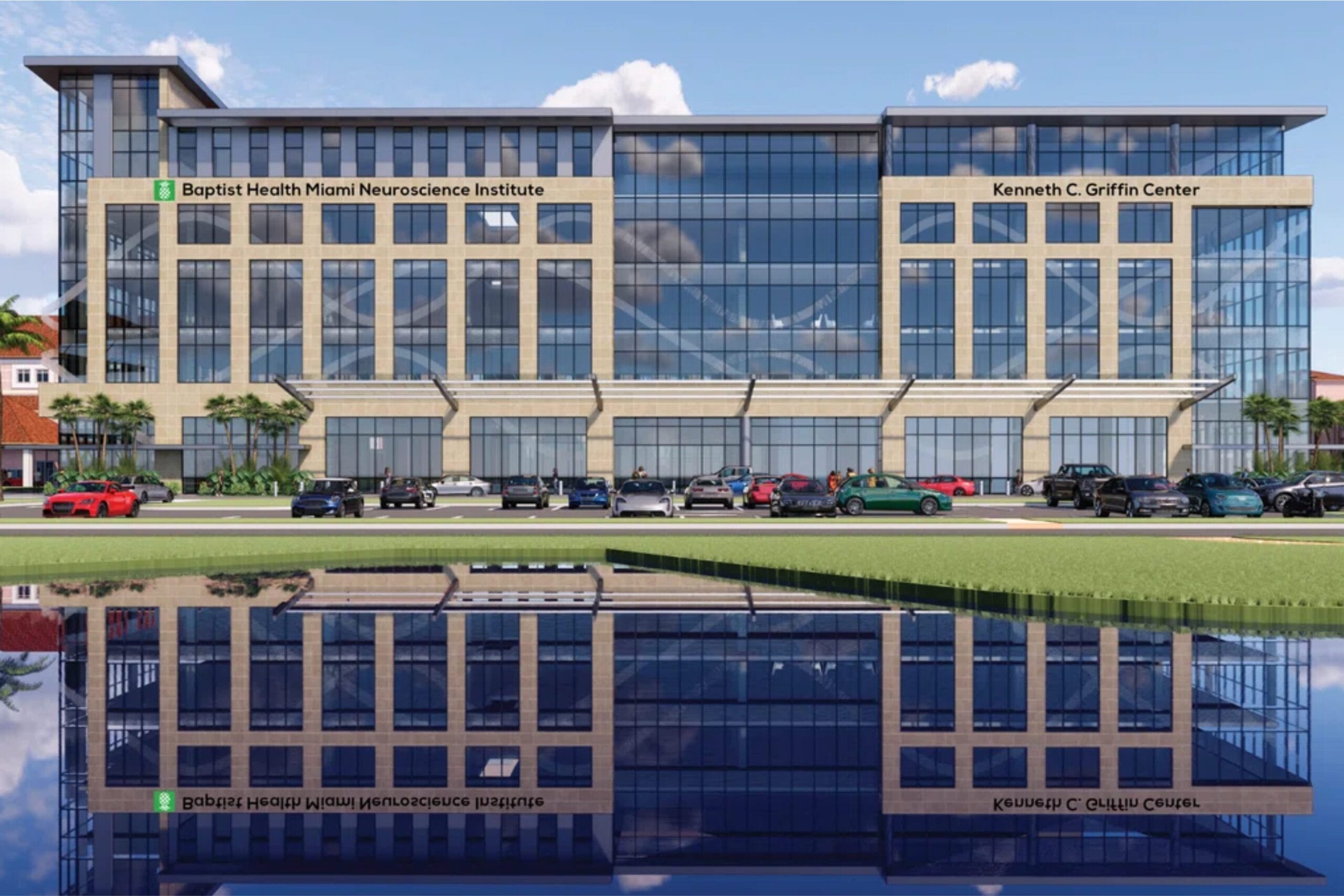 A modern glass-fronted building labeled "Baptist Health Miami Neuroscience Institute" and "Kenneth C. Griffin Center" stands behind a row of parked cars, with its reflection visible in a body of water. South Florida Business & Wealth