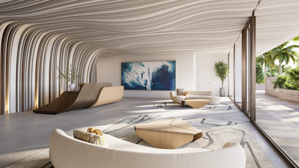 Modern, minimalist lobby with curved, wave-like ceiling and wall design, light wood and white furniture, abstract blue artwork, large windows, and a view of palm trees outside. South Florida Business & Wealth
