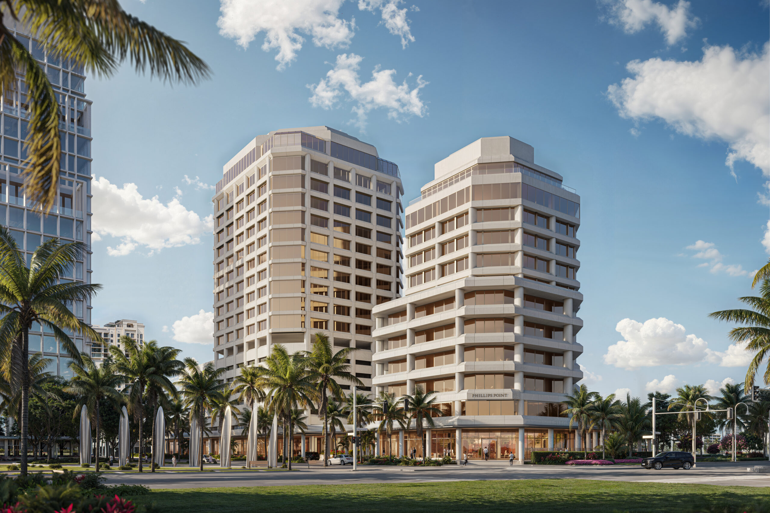 Two modern mid-rise buildings with large windows and beige exteriors stand among palm trees under a blue sky with scattered clouds. Cars and pedestrians are visible along the street in front of the buildings. South Florida Business & Wealth