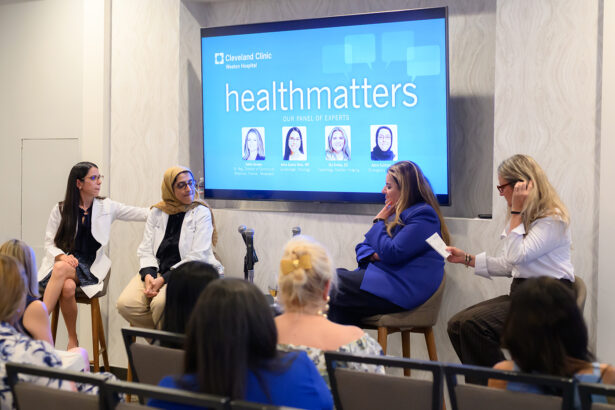 Four women sit on a panel in front of an audience at a Cleveland Clinic “healthmatters” event, with a screen behind them displaying their names and photos as expert speakers. South Florida Business & Wealth