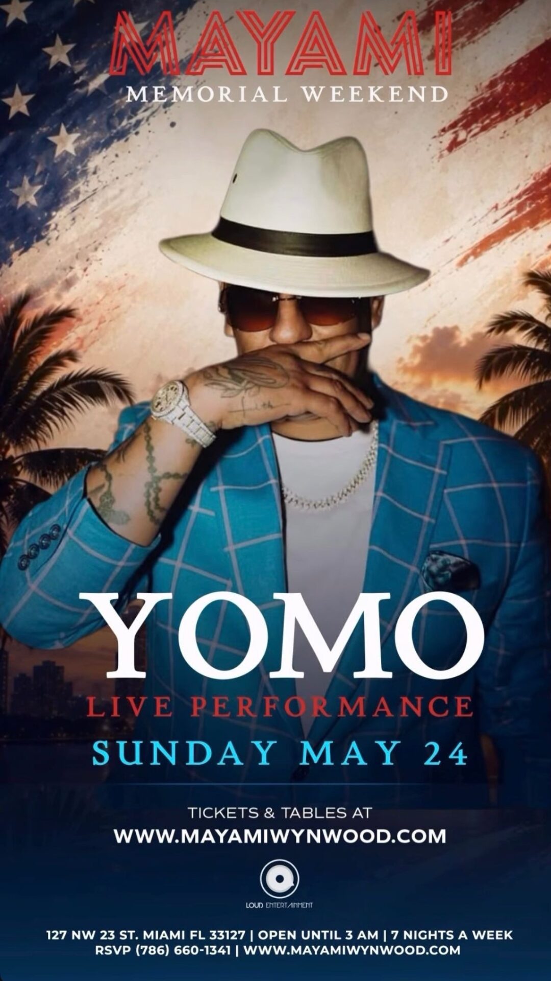 A man in a blue plaid suit, white hat, and sunglasses poses against an American flag background. Text promotes Yomo's live performance on Sunday, May 24, at Mayami in Miami for Memorial Weekend. South Florida Business & Wealth