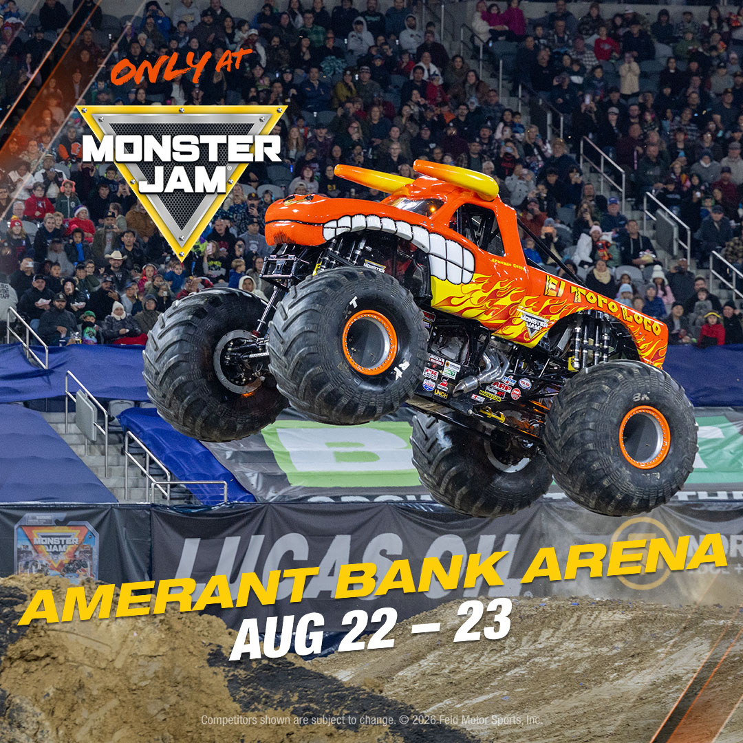 An orange monster truck with flames jumps at a Monster Jam event. Text reads "Only at Monster Jam, Amerant Bank Arena, Aug 22–23." Stadium crowd is visible in the background. South Florida Business & Wealth