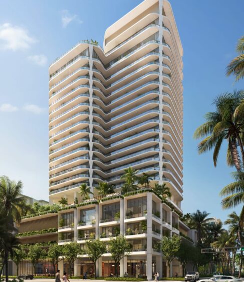 A modern high-rise building with curved balconies, lush greenery on the terraces, and a lower section featuring shops and trees, set against a clear blue sky with palm trees lining the street. South Florida Business & Wealth